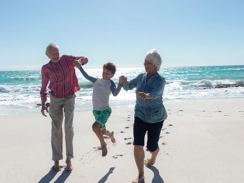 grandparents having fun on the beach with their grandson reasonable rate of return for retirement wilmington nc