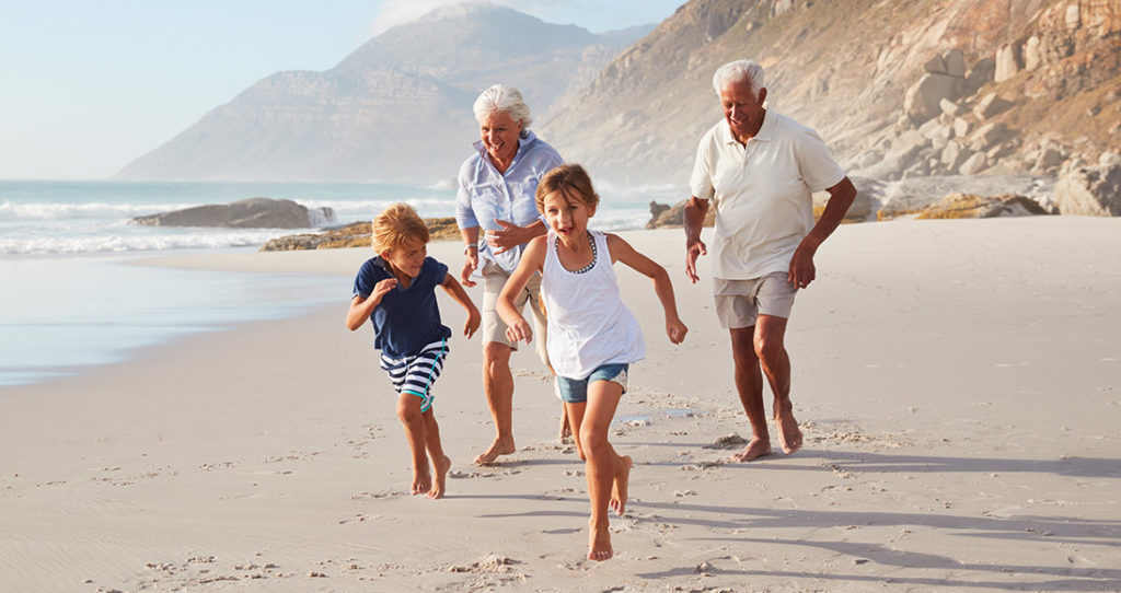 grandparents running on the beach with their grandkids annuities for retirement wilmington nc